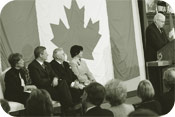 Speaker Milliken marks Flag Day against a backdrop of the original Canadian flag that flew from the Peace Tower in 1965